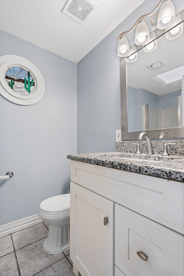 211 Second St, Denton, TX 76201 - bathroom featuring vanity, tile patterned floors, and a shower
