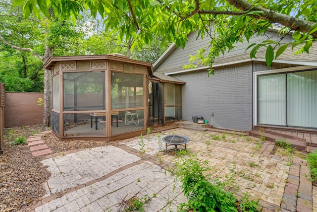 211 Second St, Denton, TX 76201 - back of property with a patio, an outdoor fire pit, a sunroom, and brick siding