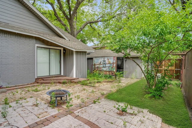211 Second St, Denton, TX 76201 - view of yard with a patio area, an outdoor fire pit, and an outbuilding