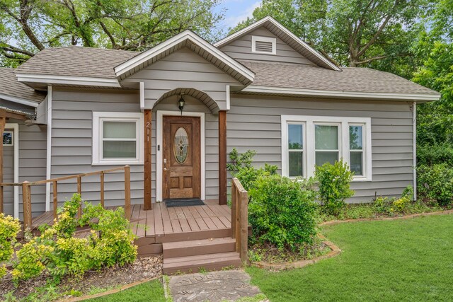 211 Second St, Denton, TX 76201 - view of front of home with a shingled roof and a front yard
