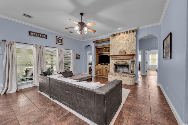 224 Cimmarron Vista Ct, Runaway Bay, TX 76426 - living area featuring arched walkways, ornamental molding, a fireplace, ceiling fan, and built in shelves