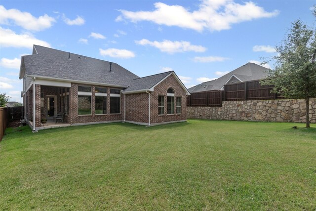 1924 Grey Bark St, Fort Worth, TX 76008 - back of property featuring brick siding, a fenced backyard, roof with shingles, and a patio
