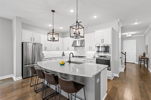 1924 Grey Bark St, Fort Worth, TX 76008 - kitchen featuring appliances with stainless steel finishes, under cabinet range hood, backsplash, an island with sink, and white cabinetry