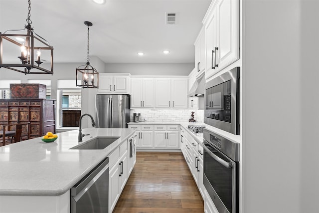 1924 Grey Bark St, Fort Worth, TX 76008 - kitchen featuring stainless steel appliances, a chandelier, recessed lighting, an island with sink, and white cabinetry
