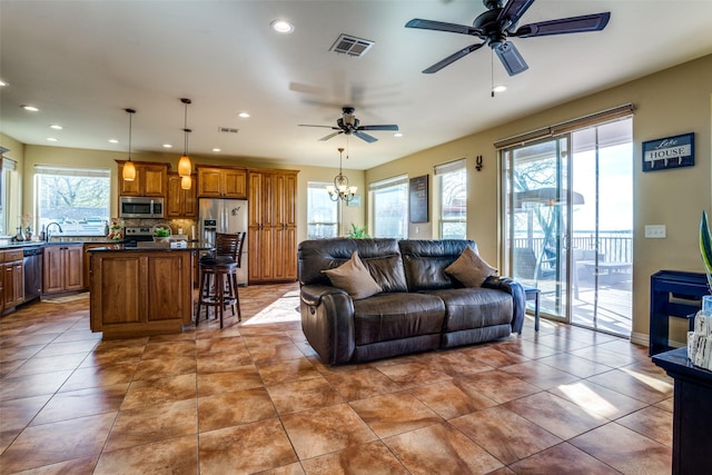 10040 Brinwood Dr, Wills Point, TX 75169 - tiled living room with plenty of natural light, ceiling fan, recessed lighting, and a chandelier