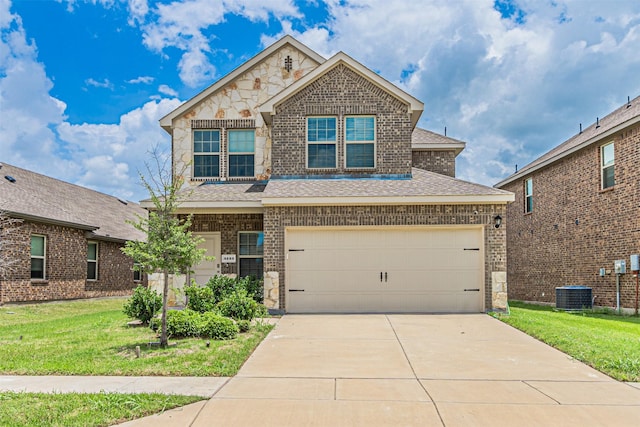 3233 Perman Dr, Mesquite, TX 75126 - view of front facade with stone siding, a front yard, a shingled roof, and concrete driveway