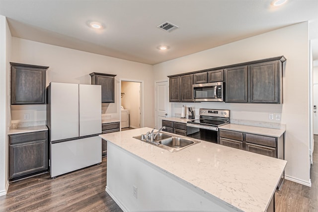 3233 Perman Dr, Mesquite, TX 75126 - kitchen with appliances with stainless steel finishes, separate washer and dryer, dark brown cabinets, dark wood-style floors, and a center island with sink