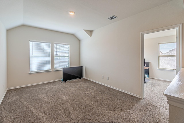 3233 Perman Dr, Mesquite, TX 75126 - spare room featuring carpet flooring and lofted ceiling