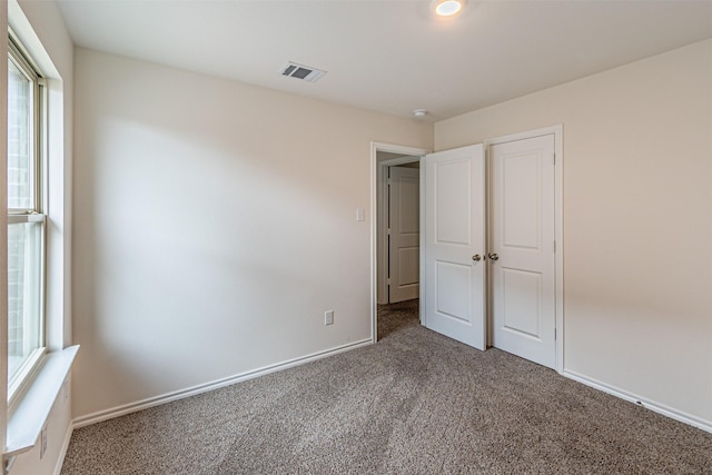 3233 Perman Dr, Mesquite, TX 75126 - unfurnished bedroom with carpet floors and multiple windows
