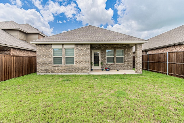 3233 Perman Dr, Mesquite, TX 75126 - rear view of property featuring brick siding, a patio area, a fenced backyard, and a shingled roof