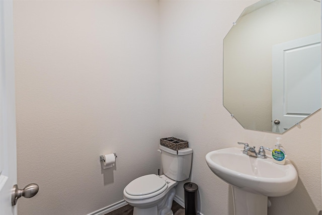 3233 Perman Dr, Mesquite, TX 75126 - half bath featuring toilet and wood finished floors