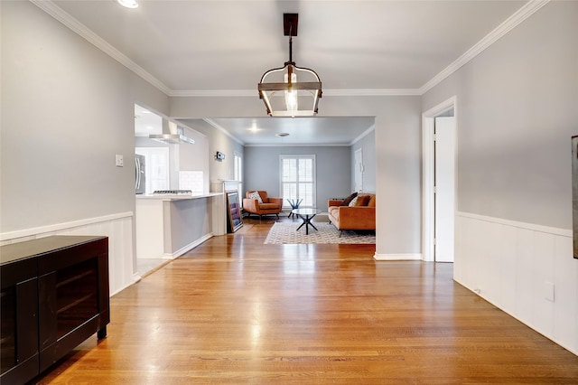 3609 Rogers Ave, Fort Worth, TX 76109 - dining room featuring light wood finished floors, a chandelier, wainscoting, and ornamental molding