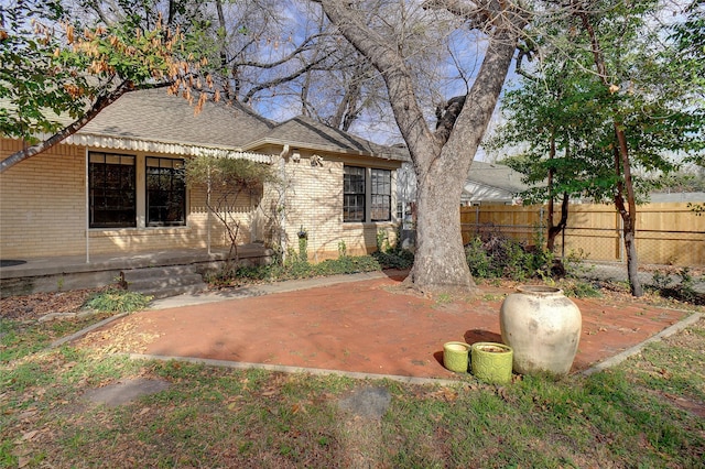 3609 Rogers Ave, Fort Worth, TX 76109 - back of house featuring brick siding, a shingled roof, and a patio area