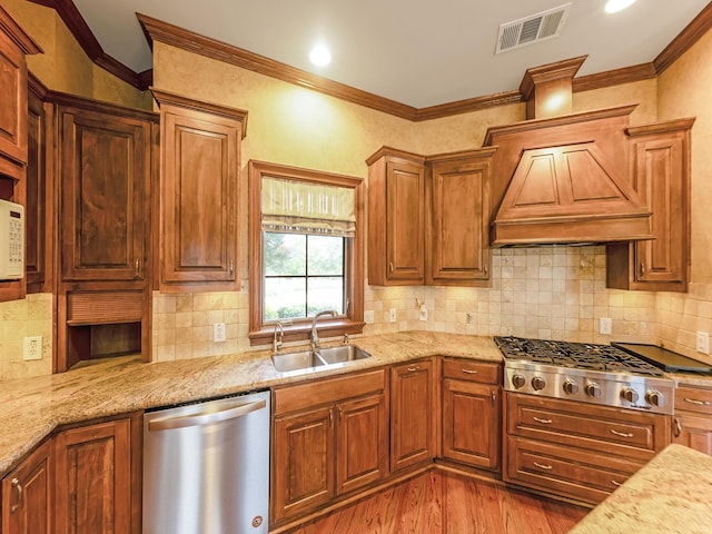 1016 Lighthouse Ct, Grand Prairie, TX 75104 - kitchen featuring stainless steel appliances, custom exhaust hood, light wood-style floors, light stone countertops, and ornamental molding