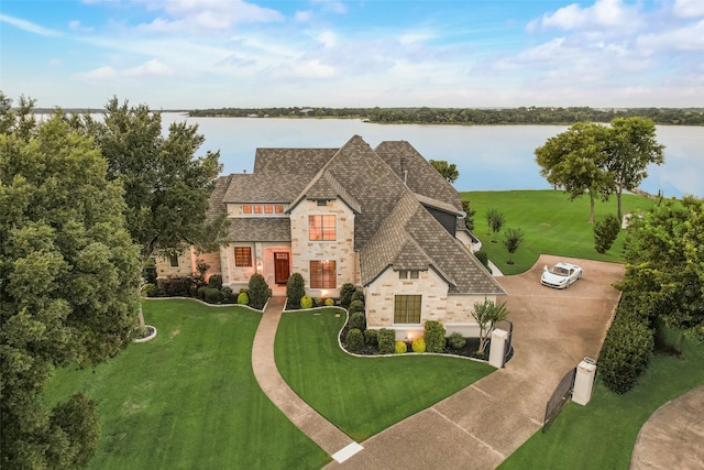 12624 Lake Shore Ct N, Fort Worth, TX 76179 - view of front of property featuring stone siding, a water view, roof with shingles, and a front yard
