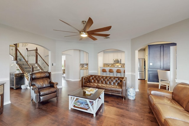 1225 Long Leaf Dr, Savannah, TX 76227 - living room with a ceiling fan, dark wood-type flooring, and arched walkways