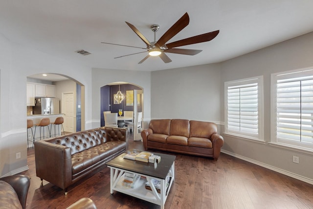 1225 Long Leaf Dr, Savannah, TX 76227 - living area with arched walkways, a ceiling fan, and dark wood-type flooring