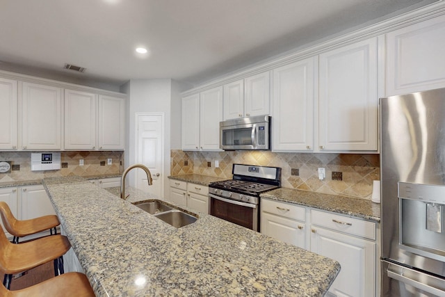 1225 Long Leaf Dr, Savannah, TX 76227 - kitchen featuring stainless steel appliances, white cabinetry, an island with sink, and recessed lighting