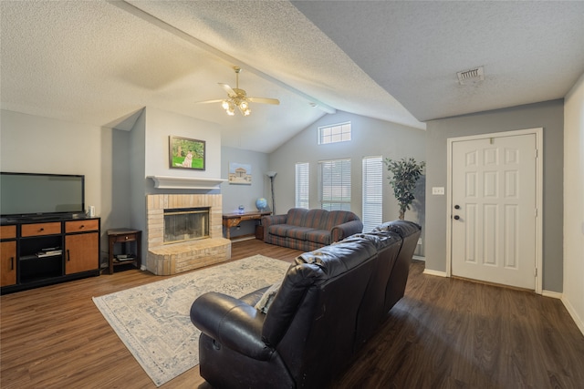 202 Lancelot Dr, Weatherford, TX 76086 - living room with lofted ceiling, wood finished floors, a ceiling fan, a brick fireplace, and a textured ceiling