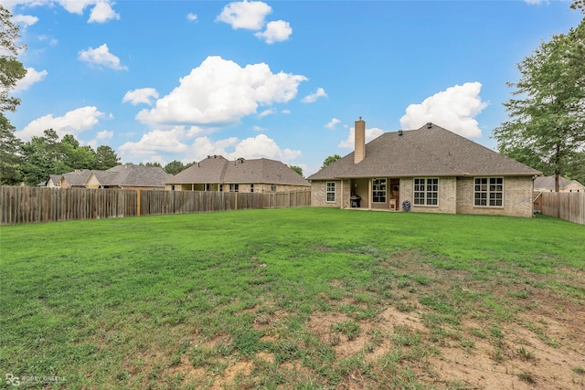 9424 N Pointe Cir, Greenwood, LA 71033 - rear view of property with a chimney, a fenced backyard, and brick siding