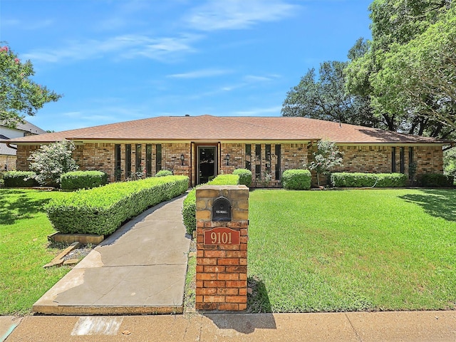 9101 Westwood Shores Dr, Fort Worth, TX 76179 - single story home with a front lawn, brick siding, and roof with shingles