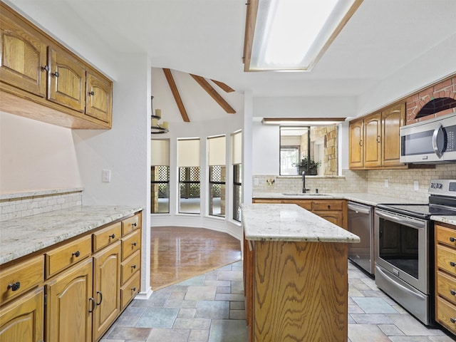 9101 Westwood Shores Dr, Fort Worth, TX 76179 - kitchen with stainless steel appliances, stone tile flooring, decorative backsplash, a center island, and light stone counters