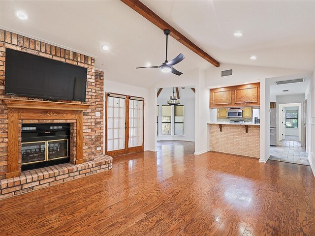 9101 Westwood Shores Dr, Fort Worth, TX 76179 - unfurnished living room with wood finished floors, ceiling fan, a brick fireplace, and recessed lighting