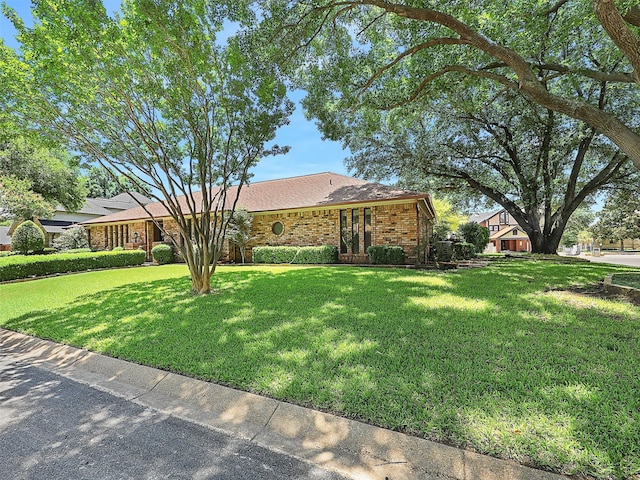9101 Westwood Shores Dr, Fort Worth, TX 76179 - view of front of property featuring a front lawn, brick siding, and a shingled roof