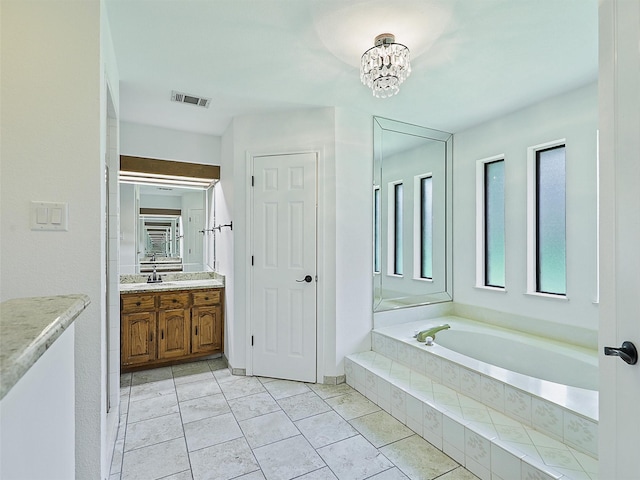 9101 Westwood Shores Dr, Fort Worth, TX 76179 - full bath with vanity, a garden tub, and a chandelier