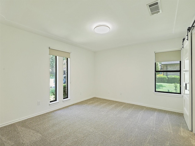 9101 Westwood Shores Dr, Fort Worth, TX 76179 - carpeted empty room featuring a barn door and plenty of natural light