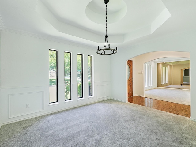 9101 Westwood Shores Dr, Fort Worth, TX 76179 - carpeted spare room featuring a raised ceiling, arched walkways, a chandelier, and ornamental molding