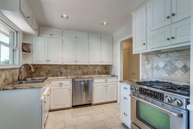448 Parkhurst Dr, Dallas, TX 75218 - kitchen featuring appliances with stainless steel finishes, backsplash, white cabinetry, and recessed lighting