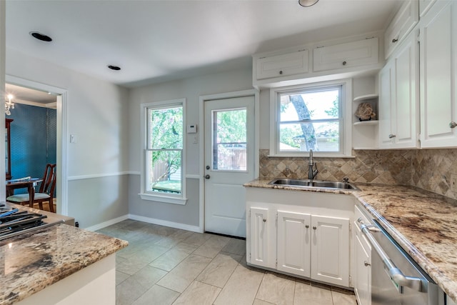 448 Parkhurst Dr, Dallas, TX 75218 - kitchen featuring stainless steel dishwasher, white cabinetry, decorative backsplash, and light stone counters