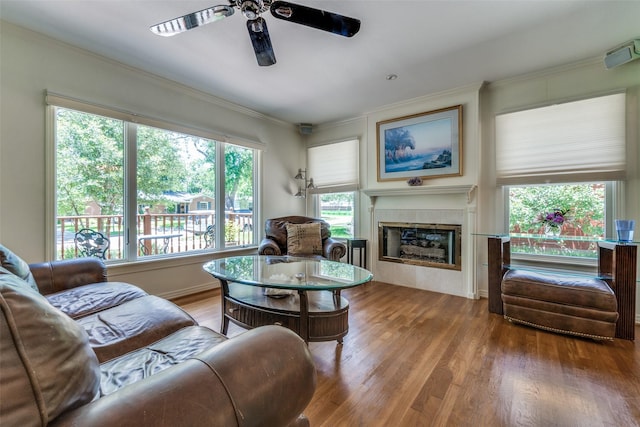 448 Parkhurst Dr, Dallas, TX 75218 - living room featuring ceiling fan, plenty of natural light, wood finished floors, a fireplace, and ornamental molding