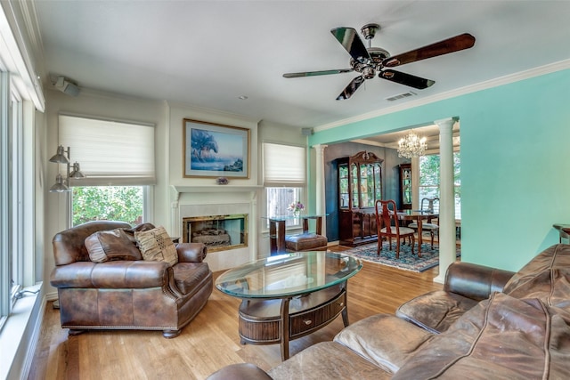 448 Parkhurst Dr, Dallas, TX 75218 - living area with a chandelier, wood finished floors, a ceiling fan, a glass covered fireplace, and ornamental molding
