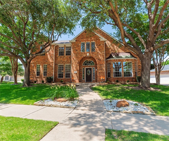 2324 Heather Ridge Dr, Flower Mound, TX 75028 - traditional-style home featuring brick siding and a front lawn