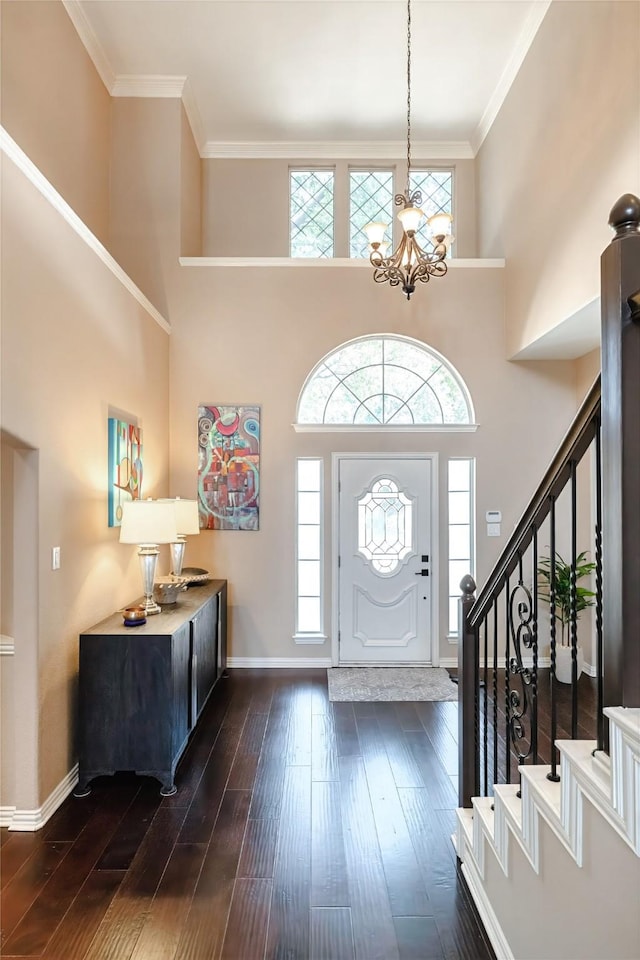 2324 Heather Ridge Dr, Flower Mound, TX 75028 - foyer entrance with a chandelier, dark wood-type flooring, stairway, crown molding, and a high ceiling