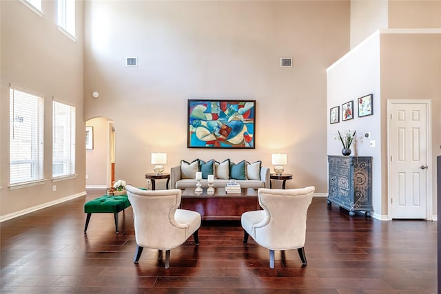 2324 Heather Ridge Dr, Flower Mound, TX 75028 - living room with a towering ceiling, arched walkways, dark wood-style floors, and healthy amount of natural light