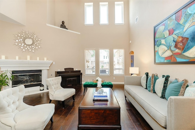 2324 Heather Ridge Dr, Flower Mound, TX 75028 - living room featuring a towering ceiling, dark wood-style flooring, and a glass covered fireplace