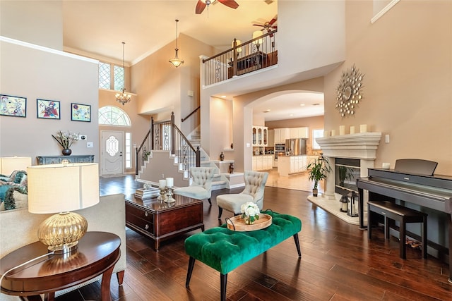 2324 Heather Ridge Dr, Flower Mound, TX 75028 - living area with a high ceiling, arched walkways, hardwood / wood-style flooring, stairway, and a ceiling fan