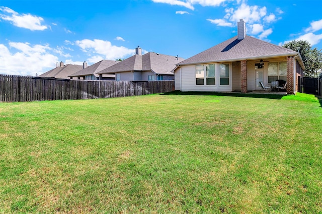 1505 Pelican Dr, Little Elm, TX 75068 - back of property featuring a fenced backyard, a ceiling fan, a patio, brick siding, and a chimney