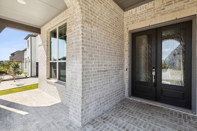 4131 Sandhills Ln, Prosper, TX 75078 - view of exterior entry with brick siding and french doors
