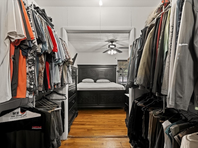 301 Redbud, Ferris, TX 75125 - walk in closet featuring ceiling fan and light wood-style flooring