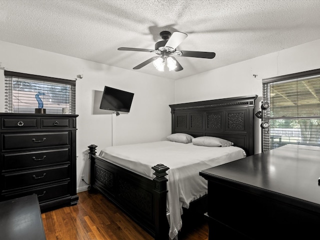 301 Redbud, Ferris, TX 75125 - bedroom with dark wood finished floors, a textured ceiling, and ceiling fan