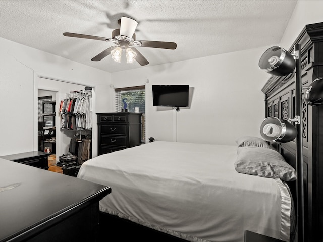 301 Redbud, Ferris, TX 75125 - bedroom featuring a textured ceiling, a closet, and a ceiling fan