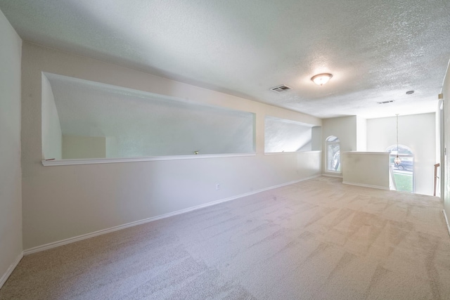 113 N W A Allen Blvd, Wylie, TX 75098 - empty room with a textured ceiling, carpet floors, and a chandelier