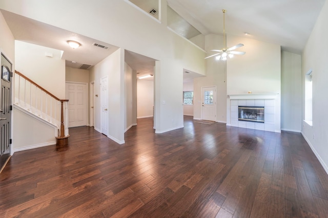 113 N W A Allen Blvd, Wylie, TX 75098 - unfurnished living room featuring a ceiling fan, dark wood-type flooring, high vaulted ceiling, stairway, and a fireplace