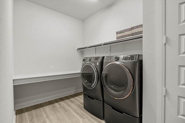 1715 Holly Oak Way, Fate, TX 75087 - laundry room with washer and dryer and light wood-style flooring
