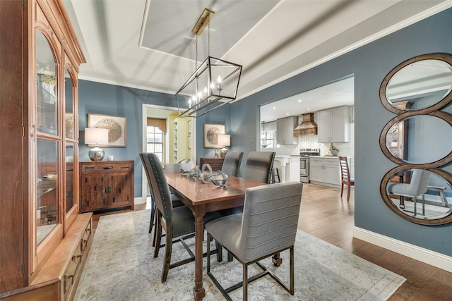 3612 Prather Ct, Arlington, TX 76017 - dining area with light wood finished floors, a chandelier, and crown molding