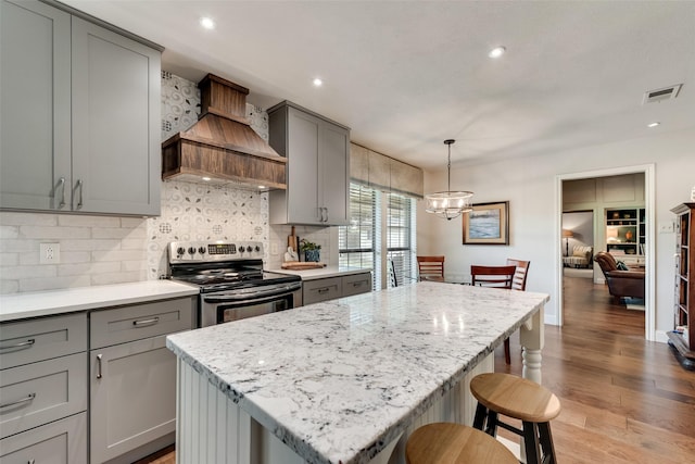 3612 Prather Ct, Arlington, TX 76017 - kitchen with gray cabinetry, stainless steel electric range oven, a center island, tasteful backsplash, and recessed lighting